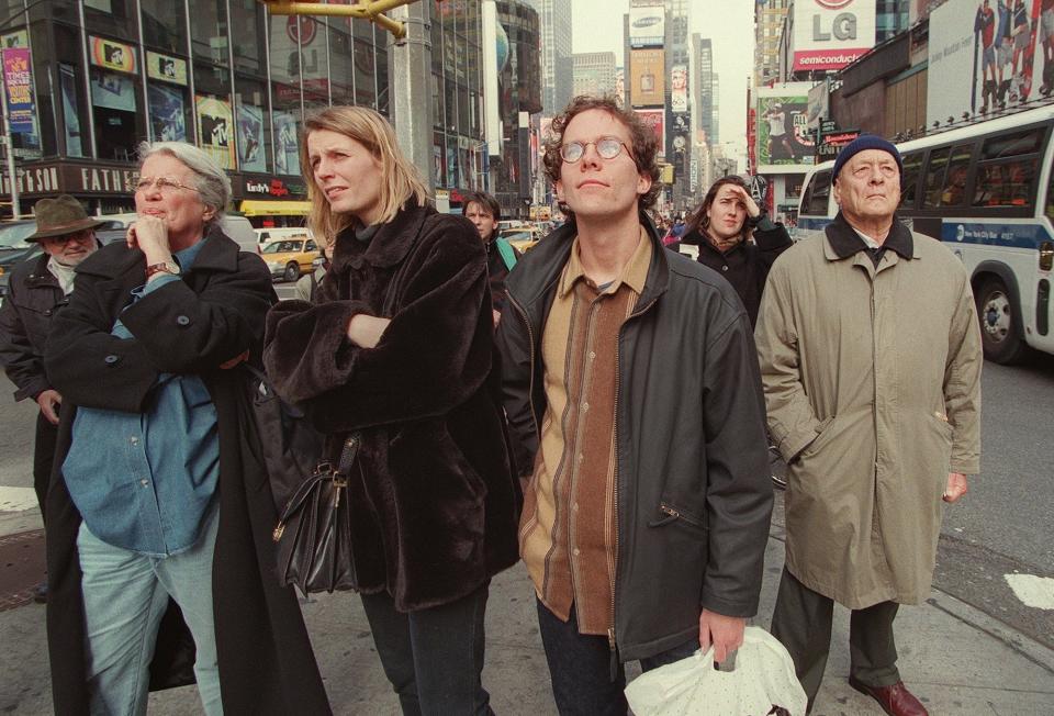 New Yorkers and tourists watch the NBC jumbotron in Times Square display the 