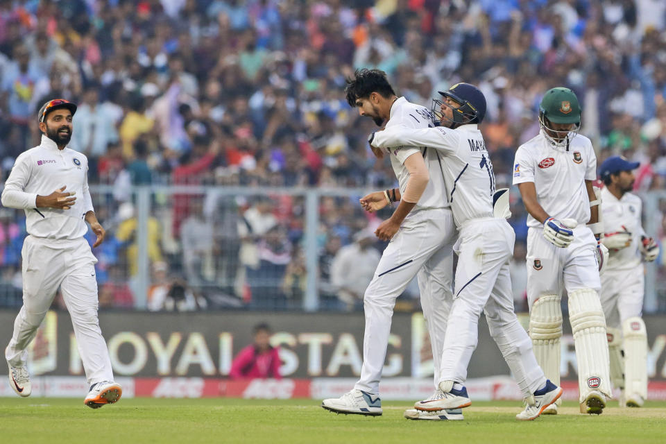 India's Ishant Sharma, second left, and Mayank Agarwal, second right, celebrate the dismissal of Bangladesh's Ebadot Hossain, right, during the first day of the second test match between India and Bangladesh, in Kolkata, India, Friday, Nov. 22, 2019. (AP Photo/Bikas Das)