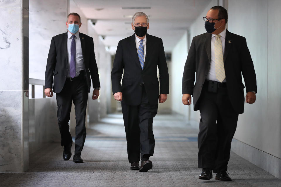 WASHINGTON, DC - SEPTEMBER 16: Senate Majority Leader Mitch McConnell (R-KY) (C) arrives for a Republican senate luncheon in the Hart Senate Office Building on Capitol Hill September 16, 2020 in Washington, DC. Speaker of the House Nancy Pelosi (D-CA) told Democratic members of the House that they would not break before the November elections unless Congress funded an additional round of stimulus to aid the economy during the novel coronavirus pandemic.  (Photo by Chip Somodevilla/Getty Images)