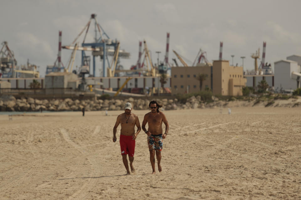 Men jog on the beach in the town of Ashkelon, Israel, Friday, May 21, 2021, aafter a cease-fire took effect between Hamas and Israel. The 11-day war between Israel and Hamas left more than 200 dead — the vast majority Palestinians — and brought widespread devastation to the already impoverished Hamas-ruled Gaza Strip. (AP Photo/Maya Alerruzzo)