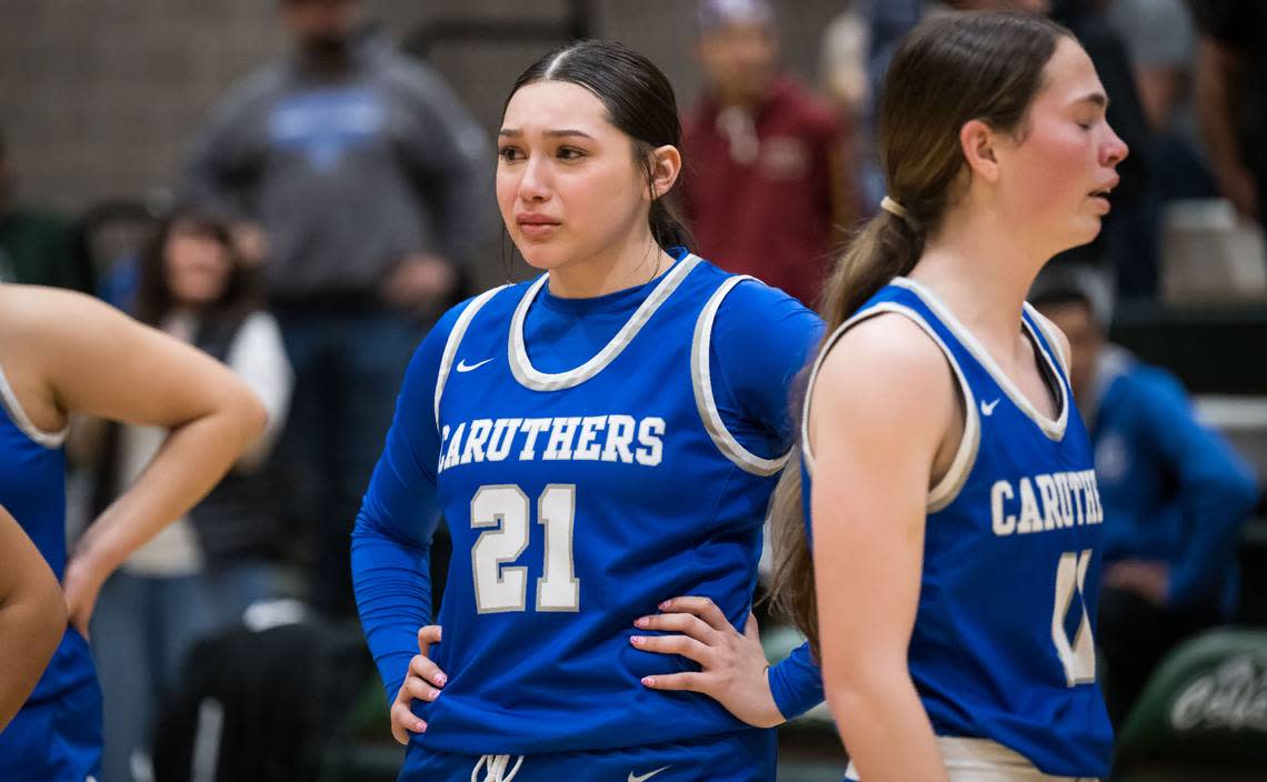 Caruthers Blue Raiders forward Lupe Lemus (21) stands quietly after her team’s close loser to the Colfax Falcons in the CIF Northern California Division III high school girls basketball championship game Tuesday, March 7, 2023, at Colfax High School. Colfax beat Caruthers, 53-52, and advances to the state championship game Friday at Golden 1 Center.