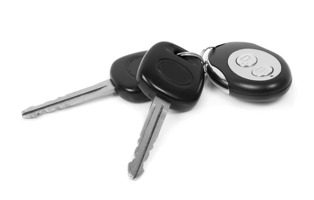 Close-Up Of Car Keys Over White Background