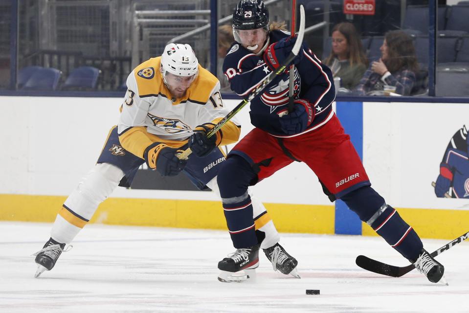 Nashville Predators' Yakov Trenin, left, and Columbus Blue Jackets' Patrik Laine chase the puck during the second period of an NHL hockey game Monday, May 3, 2021, in Columbus, Ohio. (AP Photo/Jay LaPrete)