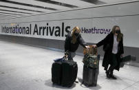 FILE - In this Jan. 17, 2021 file photo travelers arrive at Heathrow Airport in London. Britain is the fifth country in the world to record 100,000 virus-related deaths, after the United States, Brazil, India and Mexico, and by far the smallest. The U.S. has recorded more than 400,000 COVID-19 deaths, the world's highest total, but its population of about 330 million is about five times Britain's. (AP Photo/Frank Augstein, File)