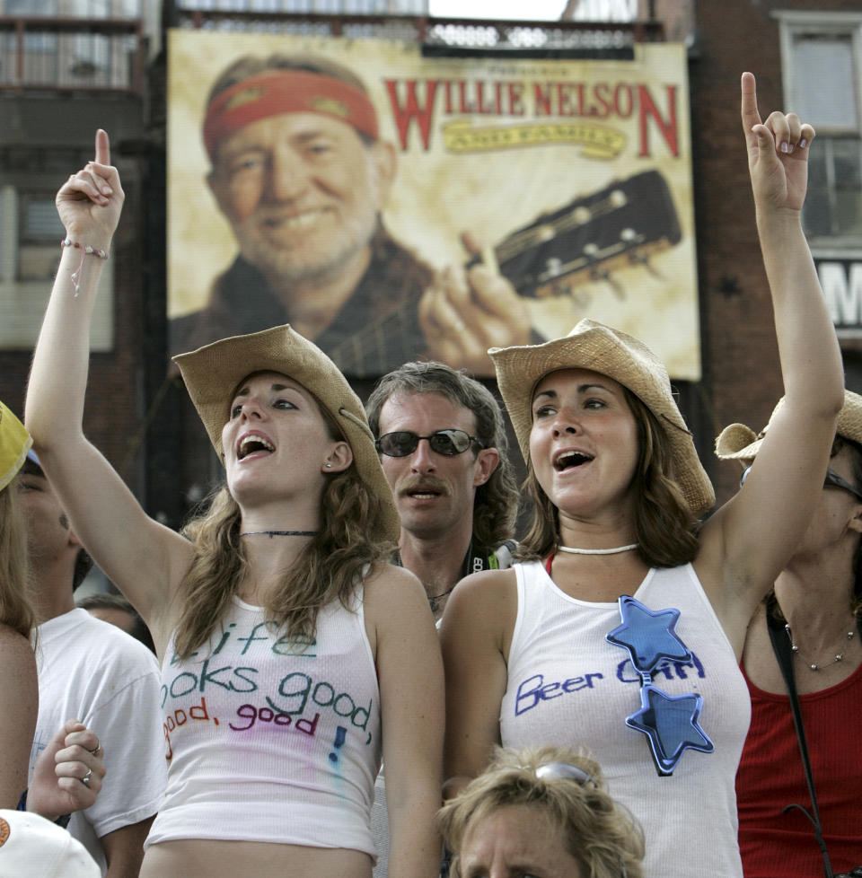 FILE -- This June 9, 2005 file photo shows Lana Deptula, left, of Crofton, Md., and Lara Wittstadt, right, of Westminster, Md., singing along at a CMA Music Festival concert in Nashville, Tenn. One of the city’s biggest parties is the annual CMA Festival, and free daytime concerts are offered. (AP Photo/Mark Humphrey, File)