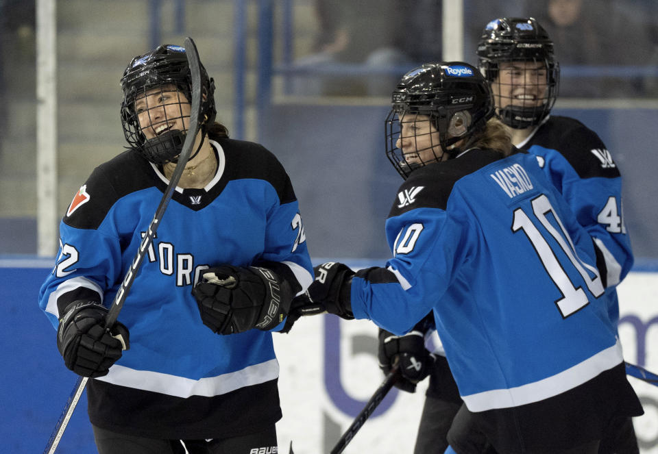 Toronto forward Maggie Connors (22) is congratulated by teammates Alexa Vasko (10) and Blayre Turnbull (40) after scoring on Boston during the second period of a PWHL hockey game in Toronto on Wednesday March 6, 2024. (Frank Gunn/The Canadian Press via AP)
