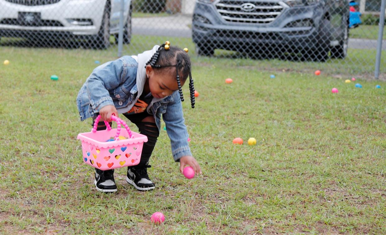 A participant takes her time gathering eggs during the Great Thunderbolt EGG Hunt at Cesaroni Park in Thunderbolt.