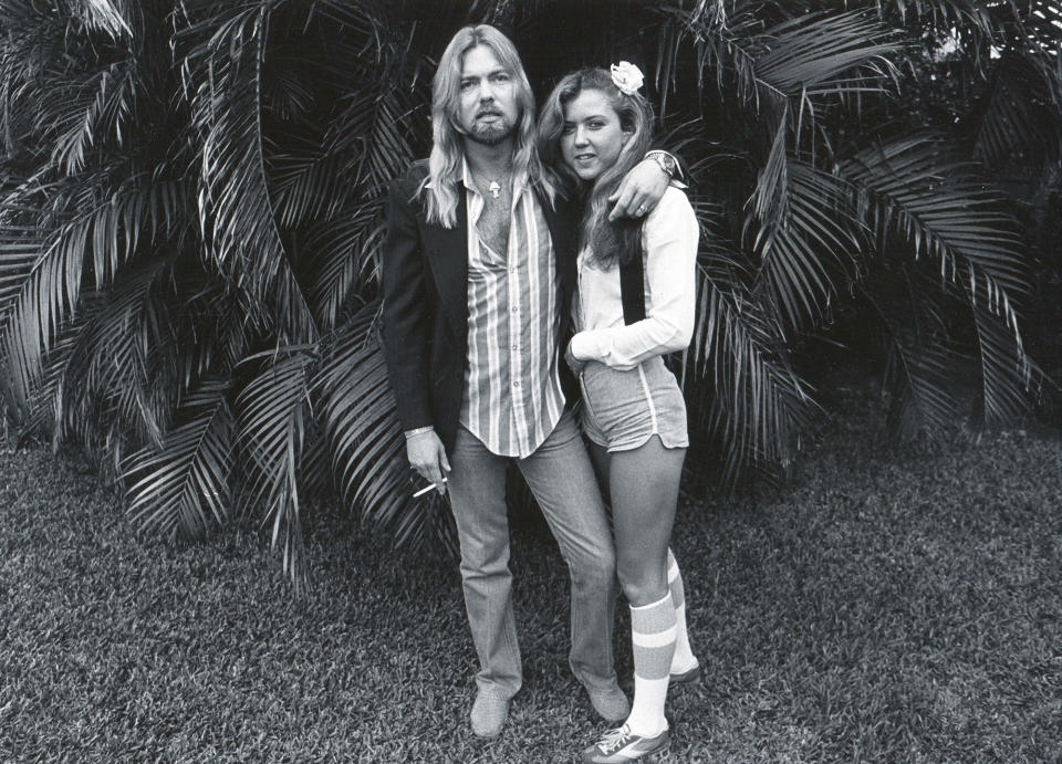 <p>Gregg Allman and his bride, Julie Bidas, as they pose in the back yard of the Palm Beach Institute, West Palm Beach, Florida, 1979. The couple married in November, but divorced in 1981. (Patrick Partington/Getty Images) </p>