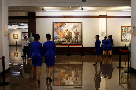 North Koreans attend the opening of a new cultural exhibition ahead of the celebrations marking the founding president Kim Il Sung's 105th birthday in Dandong, Liaoning province, China, April 14, 2017. REUTERS/Aly Song