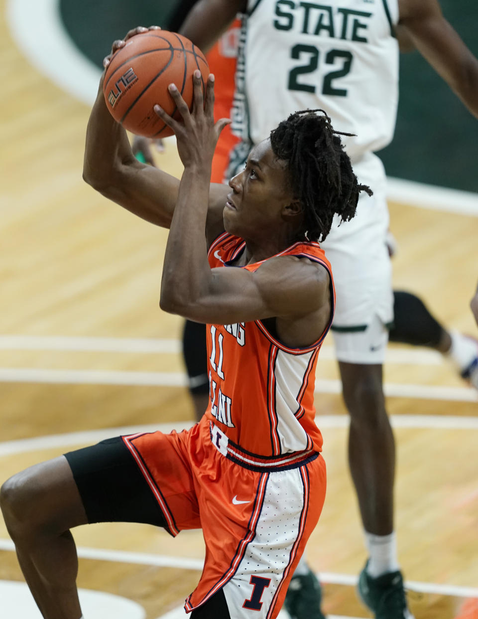 Illinois guard Ayo Dosunmu (11) makes a layup during the first half of an NCAA college basketball game against Michigan State, Tuesday, Feb. 23, 2021, in East Lansing, Mich. (AP Photo/Carlos Osorio)