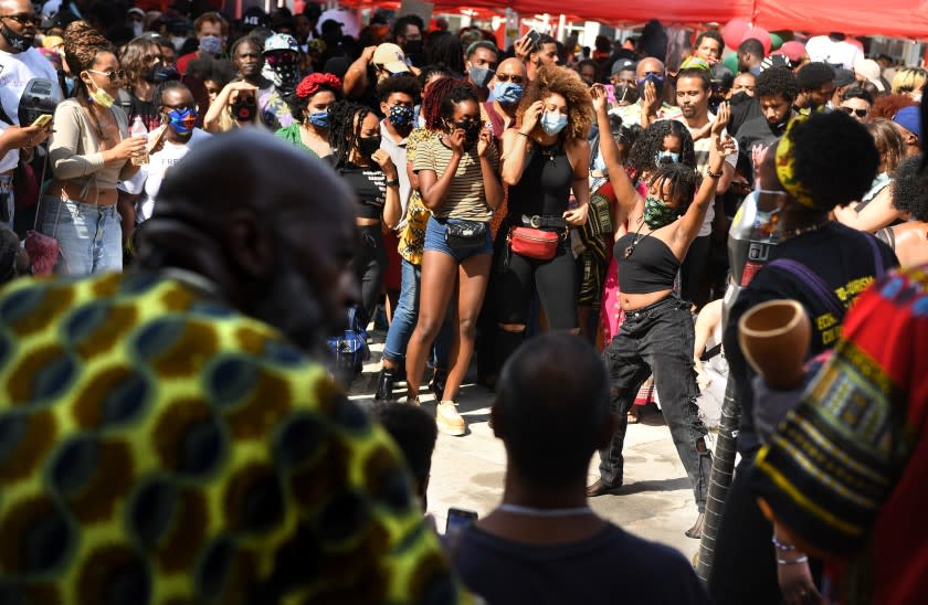 LOS ANGELES, CALIFORNIA JUNE 19, 2020-A woman dances to the music during a Juneteenth celebration at Leimert Park Friday. (Wally Skalij/Los Angeles Times)