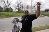 Kansas City, Kan. mayor Tyrone Garner waves to a passerby while helping volunteers clean a neighborhood park Friday, April 22, 2022, in Kansas City, Kan. Garner was elected in last November becoming the city's first Black mayor and has created a committee that would propose police reforms. (AP Photo/Charlie Riedel)