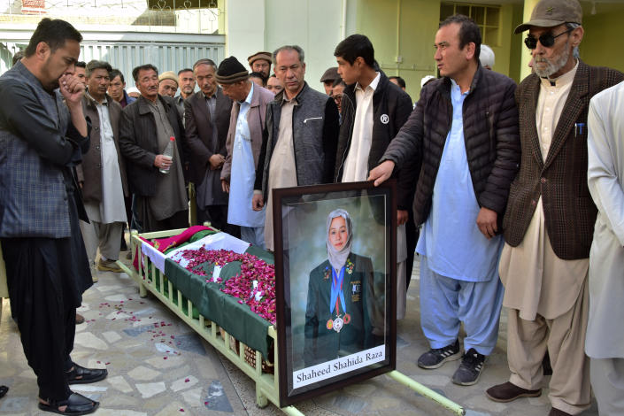 Relatives stand around the coffin of female field hockey player Shahida Raza, who died in the shipwreck tragedy, ahead of her funeral, in Quetta, Pakistan, Friday, March 17, 2023. Raza was among other migrants who died in a shipwreck off Italy's southern coast. The migrants' wooden boat, crammed with passengers who paid smugglers for the voyage from Turkey, broke apart in rough water just off a beach in Calabria. (AP Photo/Arshad Butt)