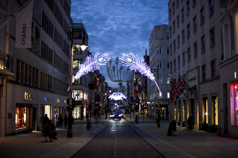 Christmas lights are lit up on New Bond Street in Mayfair, London, Tuesday, Nov. 24, 2020. Haircuts, shopping trips and visits to the pub will be back on the agenda for millions of people when a four-week lockdown in England comes to an end next week, British Prime Minister Boris Johnson said Monday. (AP Photo/Alberto Pezzali)