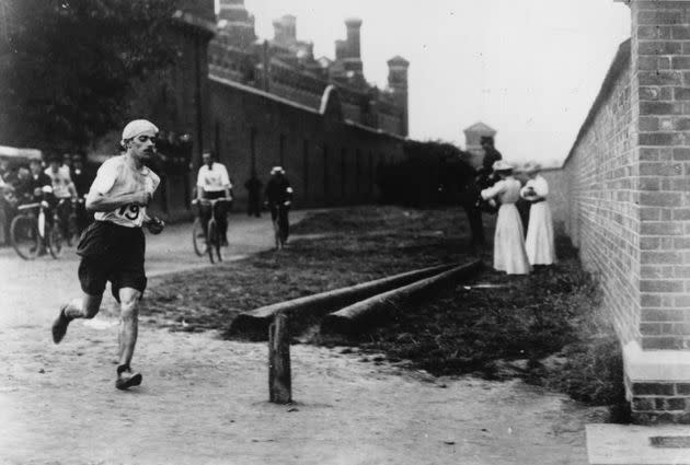 Italian runner Dorando Pietri (1885 - 1942) at Wormwood Scrubs near where he took the lead in the last mile of the Marathon event at the 1908 London Olympics, 24th July 1908. Behind him is Wormwood Scrubs prison. Despite finishing first, he was disqualified for being helped over the line after collapsing just yards from the end. The Gold Medal went to John Hayes of the USA.  (Photo by Hulton Archive/Getty Images) (Photo: Hulton Archive via Getty Images)