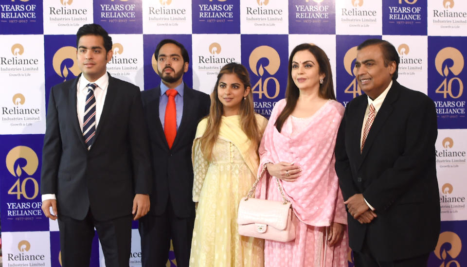 India's richest man and oil-to-telecom conglomerate Reliance Industries chairman Mukesh Ambani (R) and his wife Nita Ambani (2R) pose with their children (L-C) Akash Ambani, Anant Ambani and Isha Ambani as they arrive for the company's 40th AGM in Mumbai on July 21, 2017. 
Indian oil-to-telecom conglomerate Reliance Industries' first-quarter consolidated profit jumped 28 percent July 20, pumped up by higher margins from its core oil refining business, the group said, beating analyst estimates.
 / AFP PHOTO / INDRANIL MUKHERJEE        (Photo credit should read INDRANIL MUKHERJEE/AFP via Getty Images)