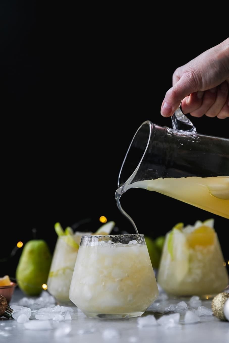 Pouring ginger Champagne cocktails.