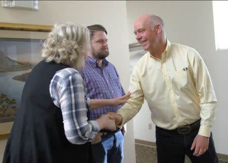 Montana Republican congressional candidate Greg Gianforte greets voters while campaigning for a special election in Missoula, Montana, U.S. May 24, 2017 in this still image from video. REUTERS/Justin Mitchell