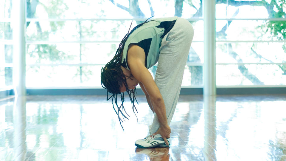 Man demonstrates yoga forward fold