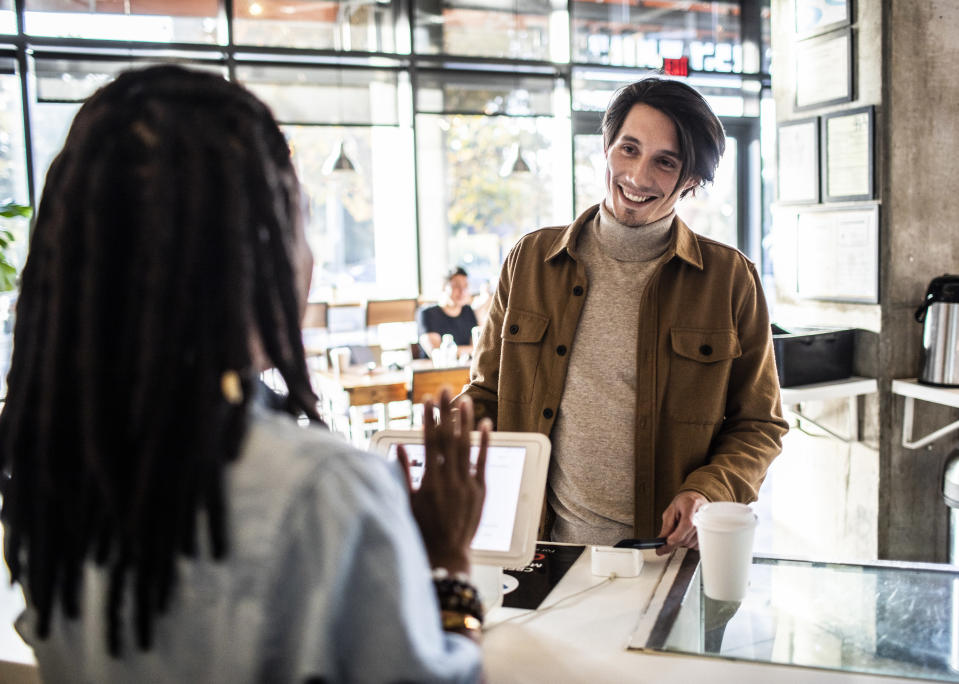 A man checking out at a counter