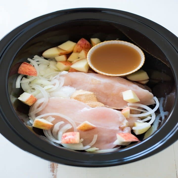 Chicken breast, onions, diced apple, and apple cider vinegar in a slow cooker