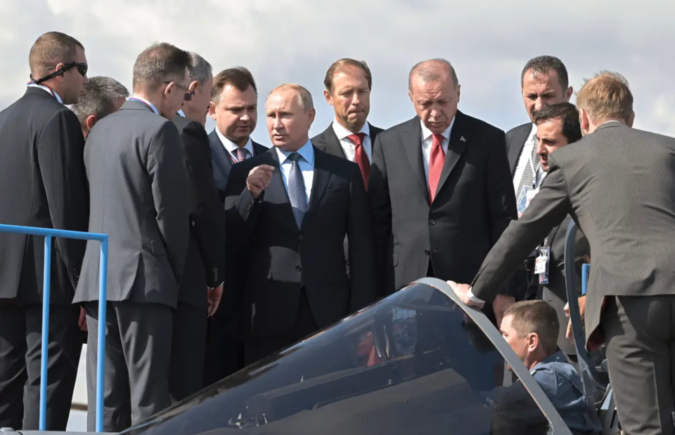 Putin and Turkish President Recep Erdogan examine a Su-57 at the MAKS airshow outside of Moscow in 2019. <em>Sergey Guneev / Sputnik via AP</em>