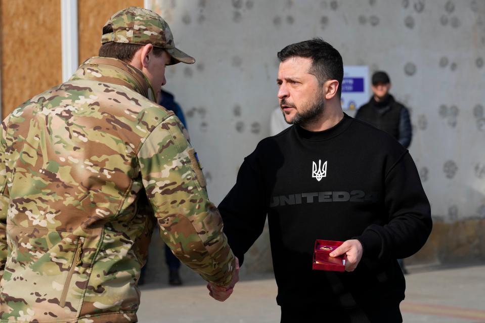 Ukrainian President Volodymyr Zelenskyy presents a medal to a serviceman in Trostianets in the Sumy region of Ukraine (AP)