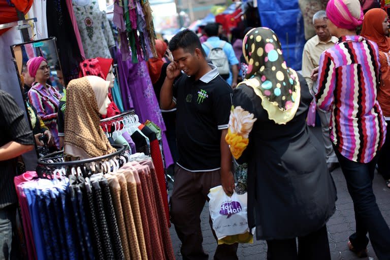 Malaysian Muslims shop ahead of the Eid al-Fitr festival in Kuala Lumpur on August 9, 2012. Malaysia has been rated the world's top Muslim-friendly holiday destination in a survey that listed Egypt, Turkey, United Arab Emirates, Saudi Arabia and Singapore as runners-up