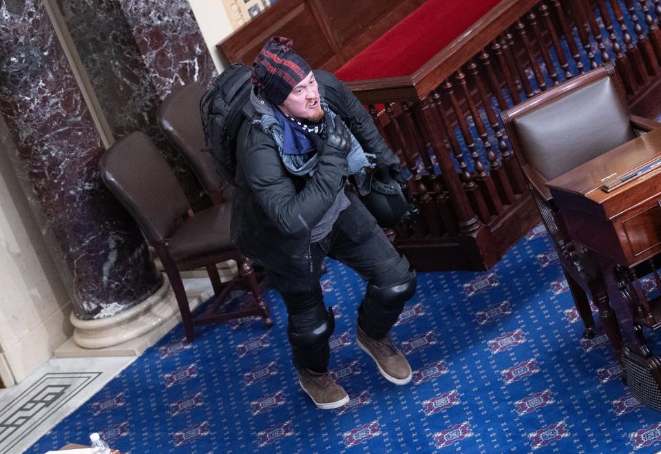 A protester supporting U.S. President Donald Trump moves to the floor of the Senate chamber at the U.S. Capitol Building on January 06, 2021 in Washington, DC. Congress held a joint session today to ratify President-elect Joe Biden's 306-232 Electoral College win over President Donald Trump.