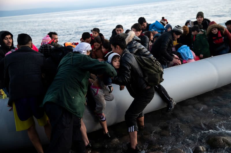 Migrants from Afghanistan arrive on a dinghy on a beach near the village of Skala Sikamias, after crossing part of the Aegean Sea from Turkey to the island of Lesbos