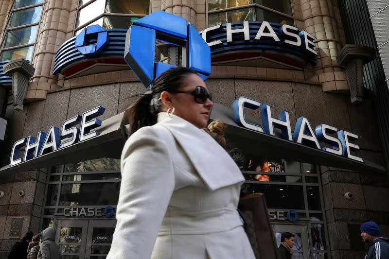 A woman passes by a JPMorgan Chase bank in Times Square in New York