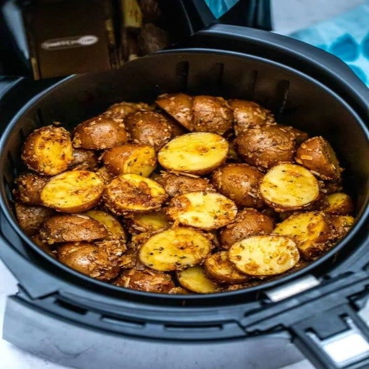 Crispy potatoes in the air fryer basket.