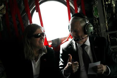 U.S. Defense Secretary James Mattis (R) gives senior advisor Sally Donnelly (L) a thumbs-up as they discuss their schedule upon arriving via helicopter at Resolute Support headquarters in Kabul, Afghanistan April 24, 2017. REUTERS/Jonathan Ernst