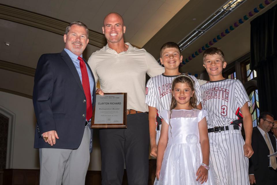 Clayton Richard (left) is inducted into the Indiana Football Hall of Fame, presented by Kevin O’Shea (left) and his children at the National Football Foundation’s Joe Tiller Chapter Honors Brunch, Sunday, Jun. 9, 2024 in West Lafayette, Ind.