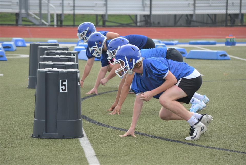 Harper Creek linemen go through a drill during the first day of two-a-days for the football preseason on Monday.