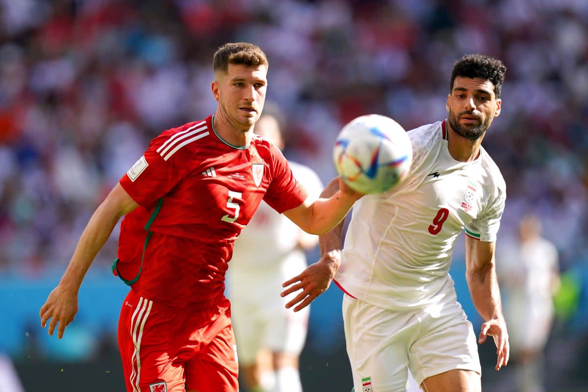 Wales defender Chris Mepham, left, battles for possession with Iran’s Mehdi Taremi during their World Cup clash on Friday (Adam Davy/PA) (PA Wire)