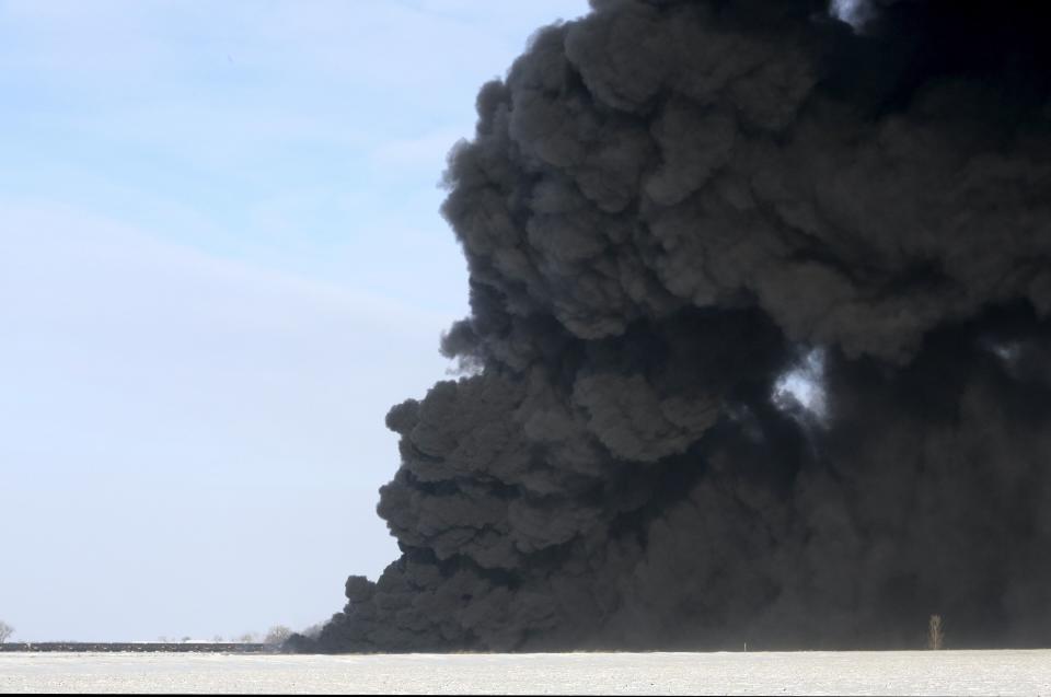 A plume of smoke rises from scene of a derailed train near Casselton, North Dakota