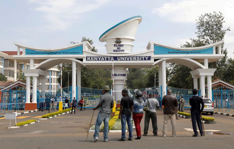 FILE PHOTO: Kenyan police officers stand in front of a gate where quarantined travellers protest being held because of the coronavirus disease outbreak for more than the usual 14 days at Kenyatta University near Nairobi