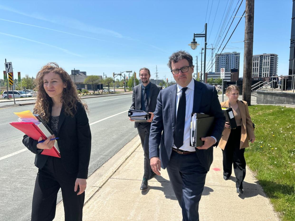 Perri Ravon, left, and Mark Power, right, are lawyers representing the Anglophone East district education council and are shown leaving the Moncton courthouse Tuesday.  (Pascal Raiche-Nogue/Radio-Canada - image credit)