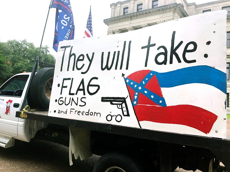 Joe Brister of Madison, Miss., says he wants to keep the Confederate battle emblem on the Mississippi state flag, which he depicted on a  sign on his truck in the parking lot of the Mississippi Capitol June 26.