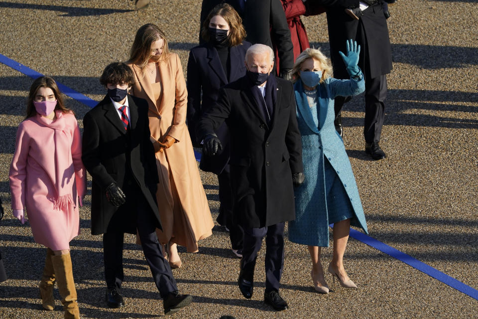 President Joe Biden and his wife Jill Biden walk in a parade during the Presidential Escort, part of Inauguration Day ceremonies, Wednesday, Jan. 20, 2021, in Washington. (AP Photo/David J. Phillip)