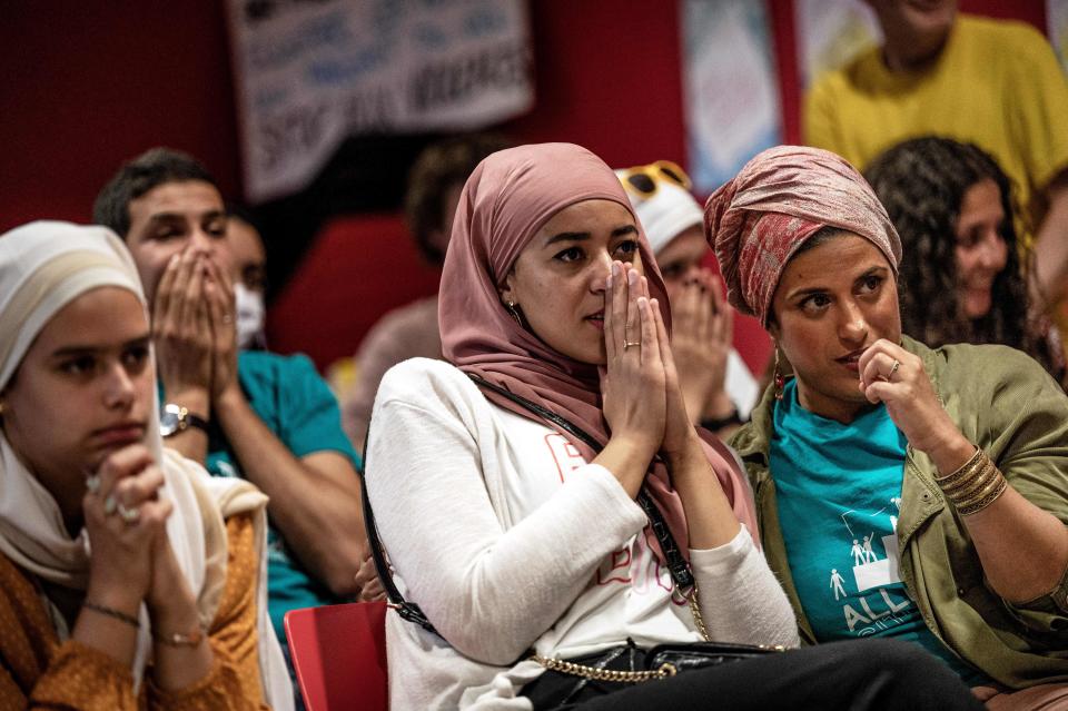 Members of the pro-burkini association « Alliance Citoyenne » watch the Municipal Council on a TV screen as members of the municipal council vote to allow or not the wearing of the burkini in the citys swimming pools, in Grenoble on May 16, 2022. (Photo by JEFF PACHOUD / AFP) (Photo by JEFF PACHOUD/AFP via Getty Images)