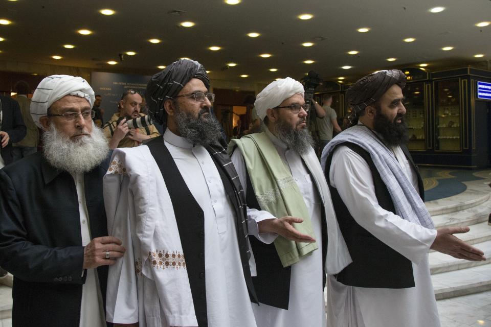 FILE - In this May 28, 2019 file photo, Mullah Abdul Ghani Baradar, the Taliban group's top political leader, second left, arrives with other members of the Taliban delegation for talks in Moscow, Russia. Afghanistan’s Taliban leaders agreed they wanted a deal with the United States, but some among them were in more of a hurry than others. Even before U.S. President Donald Trump cancelled a mysterious Camp David summit on Saturday, Sept. 7, 2019, the Taliban negotiators were at odds with the council of leaders, or shura, that rules the Islamic movement. (AP Photo/Alexander Zemlianichenko, File)