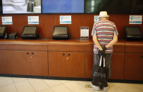 A man prepares to buy a ticket at a cinema after almost a year of theaters being closed due to the COVID-19 pandemic, in Buenos Aires, Argentina, Wednesday, March 3, 2021. (AP Photo/Natacha Pisarenko)