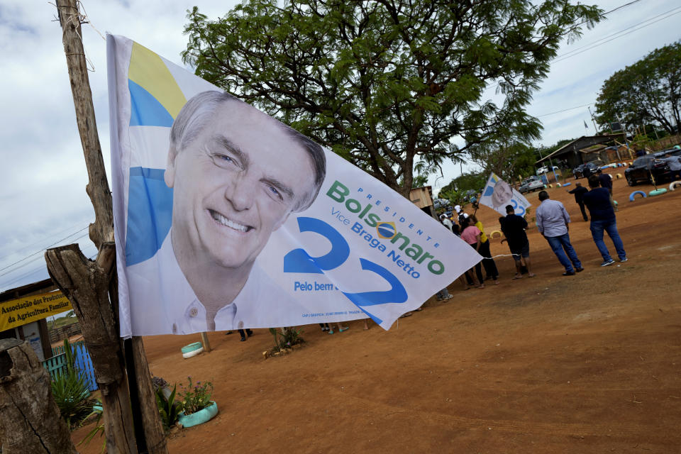 A campaign flag of Brazil's President Jair Bolsonaro flies during his campaign rally in the rural workers' settlement Nova Jerusalem, or New Jerusalem, in Brasilia, Brazil, Monday, Oct. 24, 2022. Bolsonaro is running for reelection in the presidential runoff set for Oct. 30. (AP Photo/Eraldo Peres)
