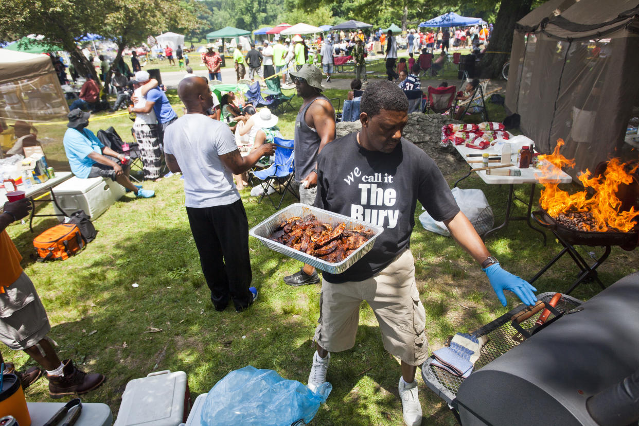 Jonathan Talley, of Roxbury, grills chicken, ribs, and sausage at Franklin Park for the Juneteenth celebration on Saturday afternoon, June 21, 2014. (Photo by Zack Wittman for The Boston Globe via Getty Images)