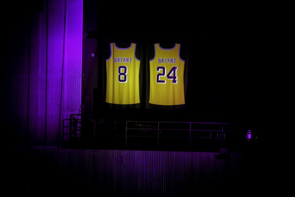 Kobe Bryant's jerseys hang high in Staples Center before a game between the Lakers and Portland.