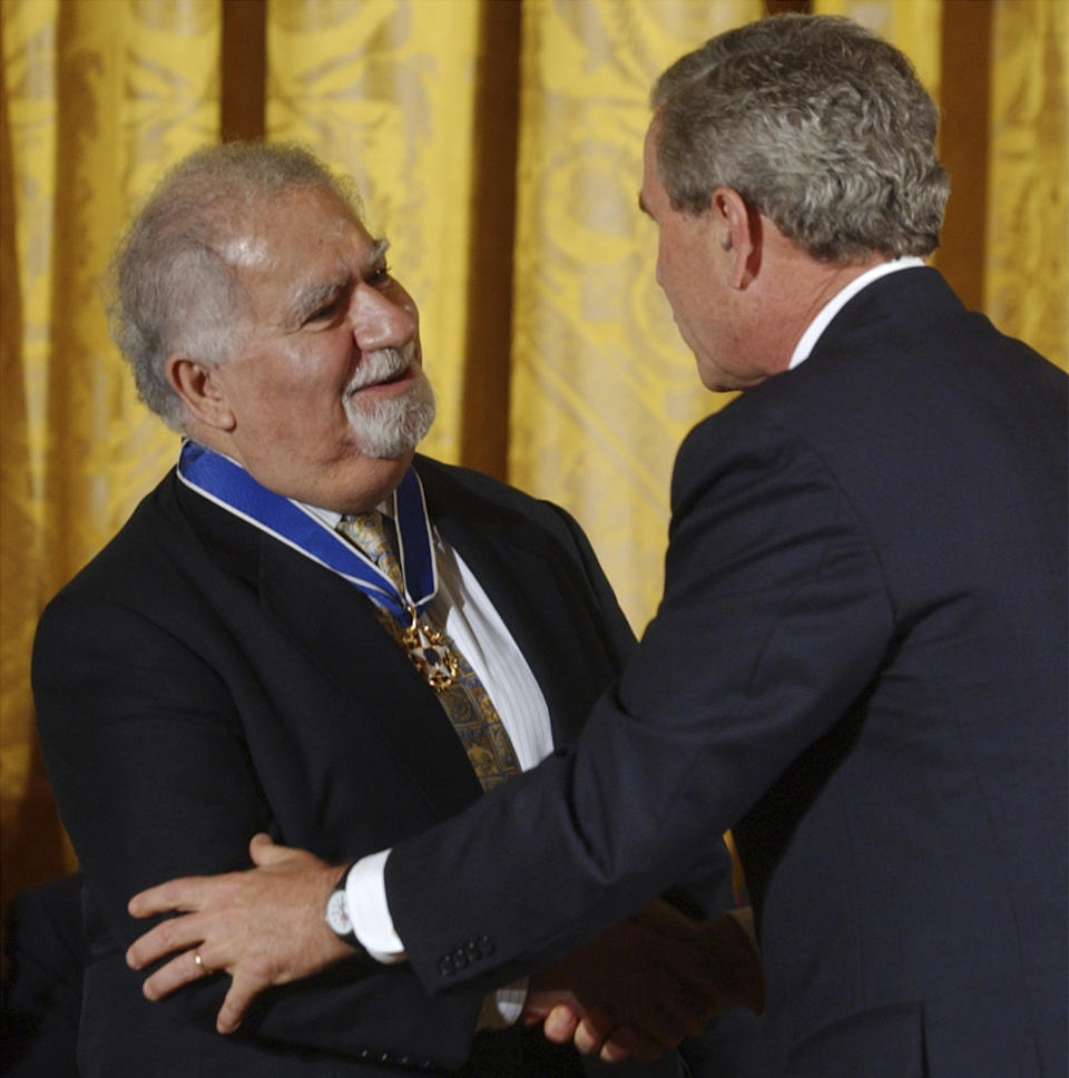 FILE - In this June 23, 2004, file photo, President Bush presents Vartan Gregorian with the Presidential Medal of Freedom, the nation's highest civil award, during a ceremony in the East Room of the White House in Washington. Gregorian, the noted scholar and philanthropic leader who has led the Carnegie Corporation of New York since 1997, died Thursday, April 15, 2021, after being hospitalized for stomach pain. He was 87. (AP Photo/Susan Walsh, File)
