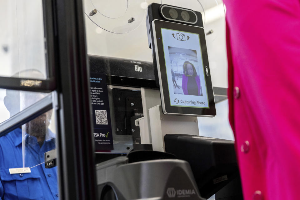 A person poses for a photo while demonstrating the Transportation Security Administration's new facial recognition technology at a Baltimore-Washington International Thurgood Marshall Airport security checkpoint, Wednesday, April 26, 2023, in Glen Burnie, Md. (AP Photo/Julia Nikhinson)