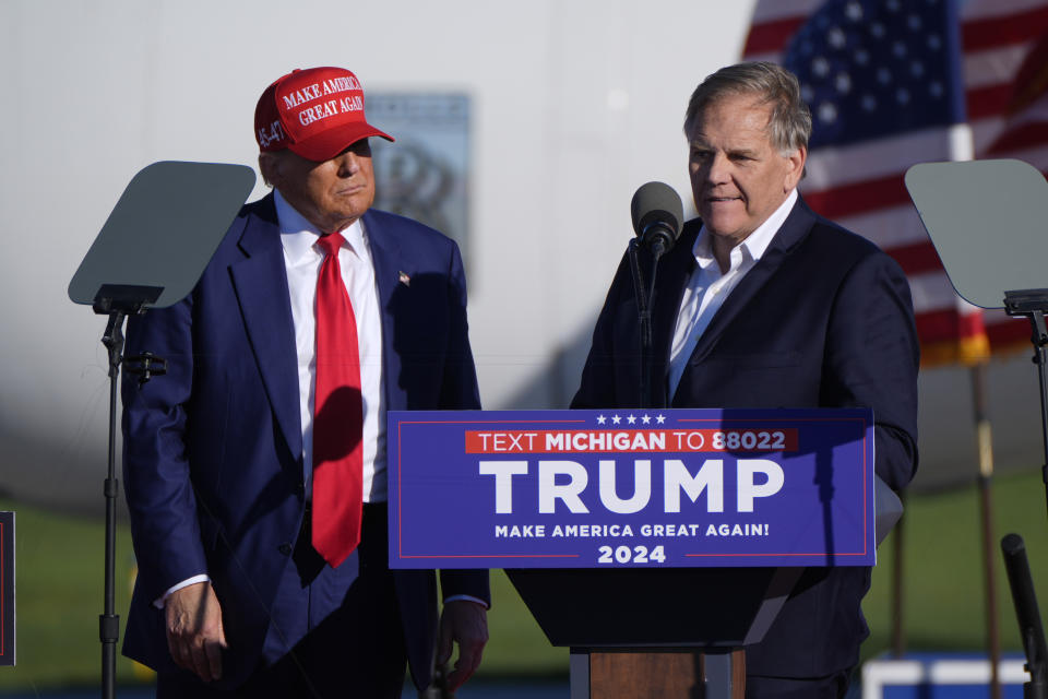 Republican presidential candidate former President Donald Trump listens as Michigan Senate candidate former Rep. Mike Rogers speaks at a campaign rally in Freeland, Mich., Wednesday, May 1, 2024. (AP Photo/Paul Sancya)